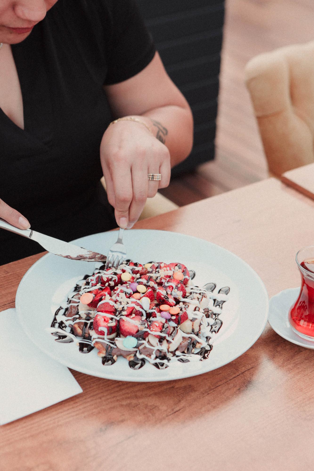Hands plating a dessert with precision
